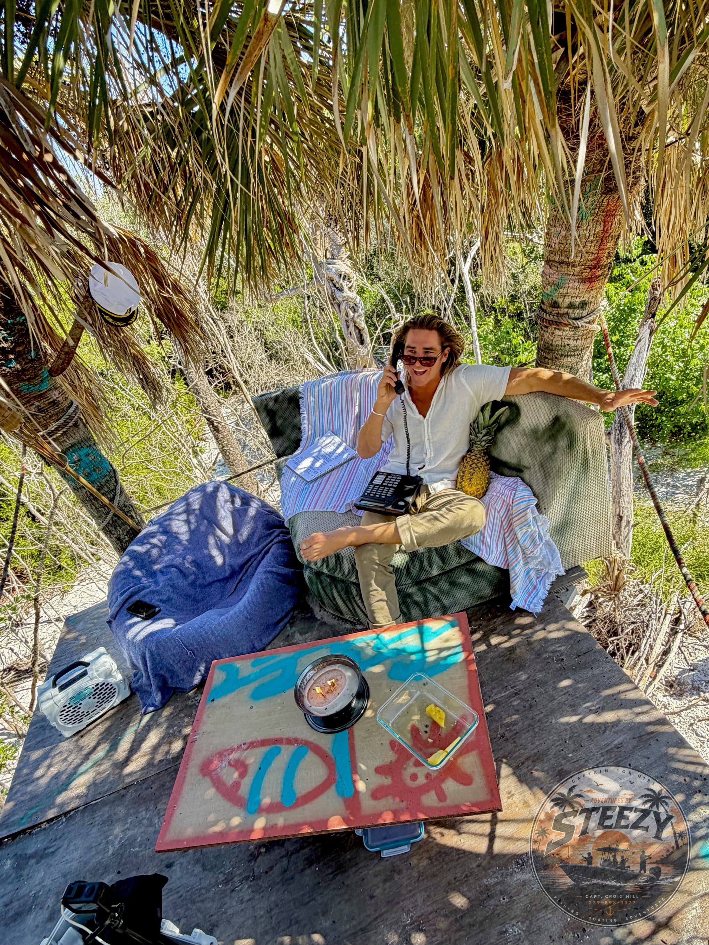 Captain Croix on a beach couch, corded phone in hand
